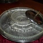 Vintage Kromex Lazy Susan Chrome & Glass Relish Tray.  Has 4 glass relish trays, dipping bowl, chrome lid, and a 13" revolving tray stand.  Measures 6"h with lid.  Pre-owned & in excellent condition, no cracks/breaks.  $30.00 obo