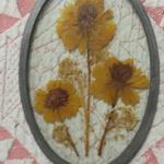 Dried Flowers in Oval Shaped Glass.  Beautiful piece.  Measures 4" x 6.5".  Pre-owned & in excellent condition.  $12.00 obo