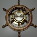 Ship's Clock on Ship's Steering Wheel.  Very unique and works great.  Measures with wheel 18" in diameter and approximately 2" wide.  Pre-owned & in excellent condition.  $120.00 obo